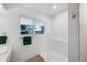 Modern bathroom with white tile, frameless shower glass, and a forest view at 814 Neville Ln, Golden, CO 80401