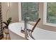 Close-up of modern bathtub with sleek fixtures and a view of the surrounding landscape at 814 Neville Ln, Golden, CO 80401