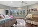 Bright bedroom with hardwood floors, many windows, and a built-in shelf for storage at 814 Neville Ln, Golden, CO 80401