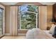 Bright bedroom with a large arched window offering scenic views, enhanced by neutral decor and soft lighting at 814 Neville Ln, Golden, CO 80401