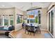 Dining area with a window seat and mountain views, featuring an elegant chandelier and designer blue and white chairs at 814 Neville Ln, Golden, CO 80401