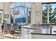 Sunlit kitchen and breakfast nook featuring mountain views through expansive windows and unique decorative accents at 814 Neville Ln, Golden, CO 80401