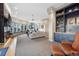 Bright living room with built-in blue shelving, large curved windows with mountain views, and recessed lighting at 814 Neville Ln, Golden, CO 80401