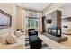 Cozy living room featuring modern decor, a fireplace with a TV, and large windows for ample natural light at 814 Neville Ln, Golden, CO 80401