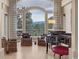 Cozy living room featuring a piano, comfortable seating, and a grand arched window with beautiful mountain views at 814 Neville Ln, Golden, CO 80401