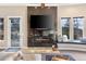 Cozy living room featuring a sleek fireplace with a stone surround, built-in bench seating, and mountain views at 814 Neville Ln, Golden, CO 80401