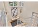 View of a bright stairwell with artwork, bench seating, and modern metal railings at 814 Neville Ln, Golden, CO 80401