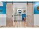 Bathroom with copper tub, white cabinets, and barn doors at 10876 Maple Rd, Lafayette, CO 80026