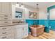 Elegant bathroom with copper tub, granite vanity, and blue wainscoting at 10876 Maple Rd, Lafayette, CO 80026