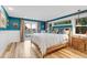 Main bedroom with light wood floors, sliding doors, and a view at 10876 Maple Rd, Lafayette, CO 80026
