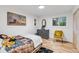 Cozy bedroom with light wood floors and a comfortable sitting area at 10876 Maple Rd, Lafayette, CO 80026