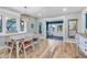 Casual dining area with light wood floors and a view to a sunroom at 10876 Maple Rd, Lafayette, CO 80026