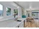 Bright kitchen features white cabinets, quartz countertops, and a farmhouse sink at 10876 Maple Rd, Lafayette, CO 80026
