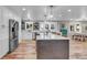 Open concept kitchen with island, stainless steel appliances, and hardwood floors at 10876 Maple Rd, Lafayette, CO 80026