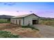 Exterior of white barn with green trim, ample parking and easy access at 5351 Tall Horse Trl, Sedalia, CO 80135
