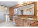 Spacious bathroom with double vanity, granite countertops, wood cabinets, a glass-enclosed shower, and luxurious design elements at 5351 Tall Horse Trl, Sedalia, CO 80135
