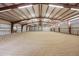 Spacious indoor horse riding arena with ample lighting and a well-maintained sand surface at 5351 Tall Horse Trl, Sedalia, CO 80135