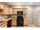 Well-equipped kitchen featuring light wood cabinetry and granite countertops with modern appliances at 5351 Tall Horse Trl, Sedalia, CO 80135
