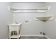 Functional laundry room with a utility sink, hanging rod, and a shelf for storage at 5351 Tall Horse Trl, Sedalia, CO 80135