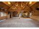Open-concept living space featuring high ceilings, exposed beams, and log walls with rustic accents at 5351 Tall Horse Trl, Sedalia, CO 80135