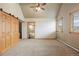 Bright and spacious bedroom with a sliding barn door to an ensuite bathroom, soft carpet, and a bright window with stunning view at 5351 Tall Horse Trl, Sedalia, CO 80135