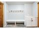 Bright mudroom featuring a built-in bench, coat hooks, and a convenient storage cabinet at 5351 Tall Horse Trl, Sedalia, CO 80135