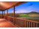 Spacious covered porch with wood railing offering mountain views at 5351 Tall Horse Trl, Sedalia, CO 80135