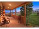 Cozy porch with wooden rocking chairs and rustic details, overlooking the serene landscape at 5351 Tall Horse Trl, Sedalia, CO 80135