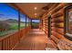 Covered porch with wood flooring and views of the lush landscape at 5351 Tall Horse Trl, Sedalia, CO 80135