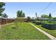 Spacious grassy backyard with beautiful garden beds and storage shed at 1240 Ulster St, Denver, CO 80220