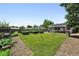 Spacious backyard featuring a well-maintained lawn, established garden beds, and a charming patio at 1240 Ulster St, Denver, CO 80220