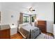 Cozy bedroom with a ceiling fan, two windows, and hardwood floors at 1240 Ulster St, Denver, CO 80220