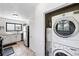 Bright kitchen complemented by an adjacent laundry area with modern washer and dryer at 1240 Ulster St, Denver, CO 80220