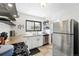 Well-lit kitchen with granite countertops, stainless steel appliances, and ample storage space at 1240 Ulster St, Denver, CO 80220