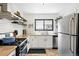 Efficient kitchen featuring stainless steel appliances, granite counters, and a functional layout at 1240 Ulster St, Denver, CO 80220