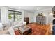 Cozy living room boasting hardwood floors, comfortable seating, and views of the front yard at 1240 Ulster St, Denver, CO 80220