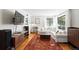 Spacious living room featuring hardwood floors, ample seating, and a modern entertainment setup at 1240 Ulster St, Denver, CO 80220