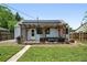Back of house with a cozy outdoor patio featuring a pergola and lattice at 1240 Ulster St, Denver, CO 80220