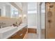 Modern bathroom featuring dual sinks, quartz countertops, decorative tile backsplash, and a glass-enclosed shower at 35 S Forest St, Denver, CO 80246