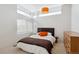 Modern bedroom with orange accents, neutral carpet, and large windows at 35 S Forest St, Denver, CO 80246