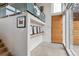 Modern entryway featuring a light wood door, clean lines, artwork display shelf and an open staircase design at 35 S Forest St, Denver, CO 80246