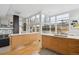 Bright open kitchen with light wood cabinets and a view into the living area and outdoor space at 35 S Forest St, Denver, CO 80246