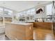 Bright, modern kitchen with an island, light wood cabinets, and large windows at 35 S Forest St, Denver, CO 80246