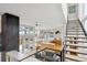 Bright and airy living room features an open floor plan with a modern staircase and large windows at 35 S Forest St, Denver, CO 80246