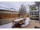 Covered patio featuring a dining area and snow covered outdoor seating at 35 S Forest St, Denver, CO 80246