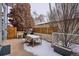 Snowy outdoor patio with a dining table, chairs, and a modern privacy fence at 35 S Forest St, Denver, CO 80246