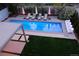 Aerial view of a backyard pool with lounge chairs, umbrellas, and well-maintained landscaping at 35 S Forest St, Denver, CO 80246