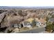 An aerial view of a neighborhood with well-maintained homes and mature trees, near roads and scenic mountain views at 3311 E Euclid Ave, Centennial, CO 80121