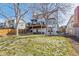 Expansive backyard featuring an upper deck, lower patio with seating, and ample green space at 3311 E Euclid Ave, Centennial, CO 80121