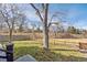 Backyard shows well-maintained lawn surrounded by mature trees and a rustic fence at 3311 E Euclid Ave, Centennial, CO 80121